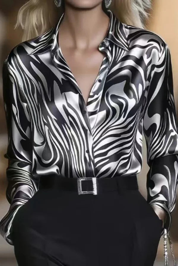 Chic women's zebra print button down blouse with elegant sheen, ideal for professional work attire or a stylish evening top.