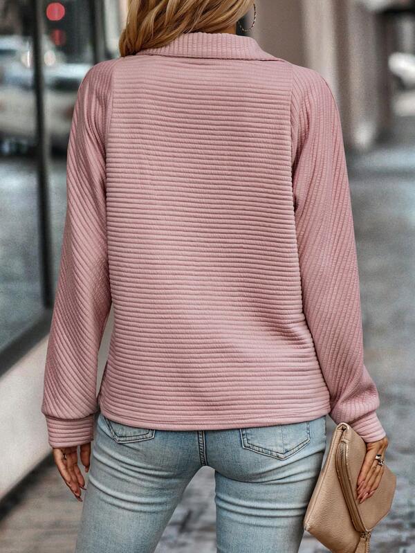 Woman modeling a stylish V-neck zippered sweater, perfect for casual chic or professional office wear.