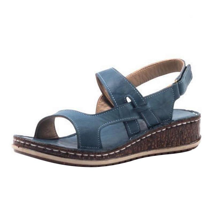 "Elegant women's strappy wedge sandals with open toes, slingback straps, and a cork-look base, perfect for summer style."