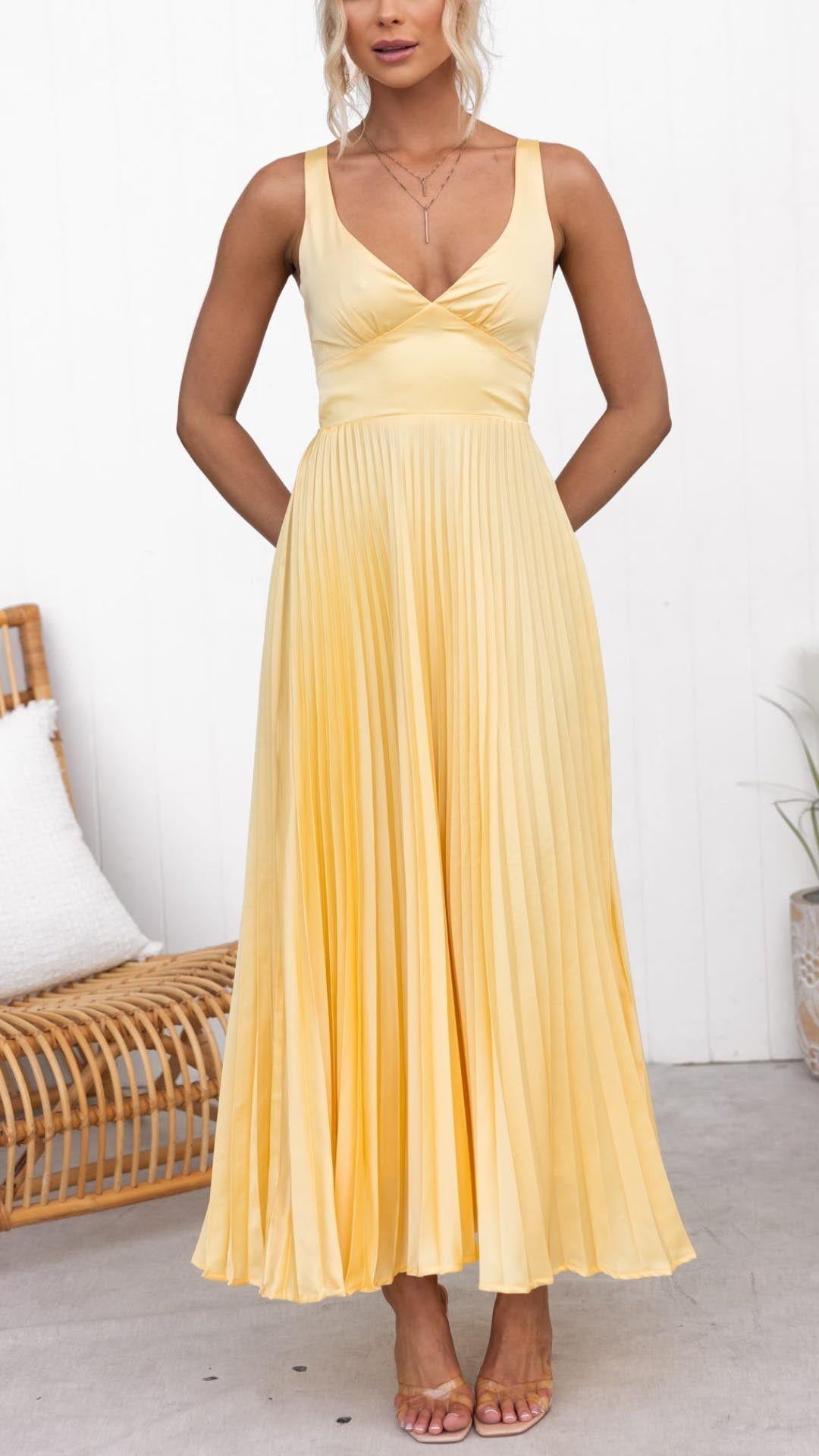 Chic women's V-neck pleated midi dress in vibrant yellow, ideal for wedding guests, with flattering silhouette.