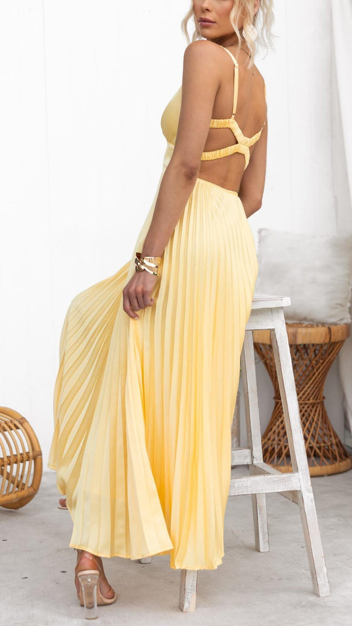 Women's chic yellow pleated V-neck midi dress featuring a flowy skirt, perfect for a comfortable wedding guest outfit.