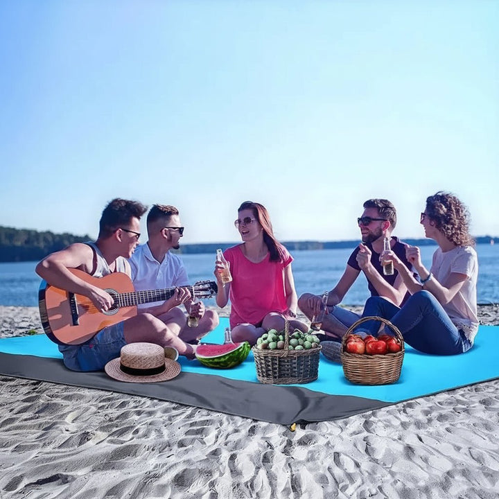 Lightweight, sandproof picnic mat; a portable outdoor essential for parks, beaches & camping.