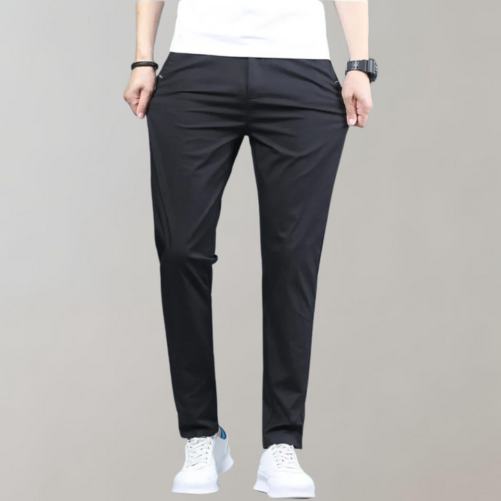 Detail shot of the button and zipper closure on men's comfortable slim-fit casual pants for a secure fit.