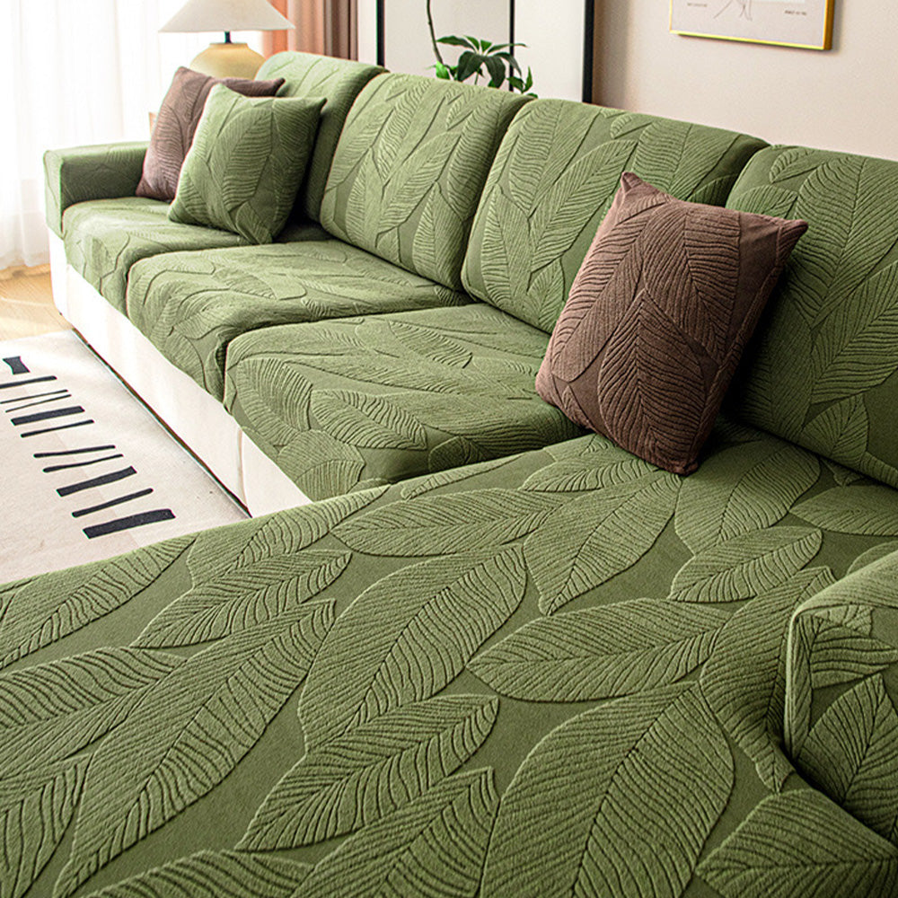 Modern stretch sofa cover with elegant leaf jacquard design. Full wrap protection, pet & spill resistant.