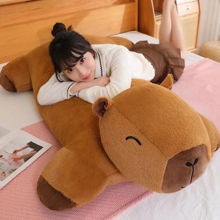 Unisex capybara plushie, a giant soft animal toy & stress relief cuddle buddy. Unique gift idea.