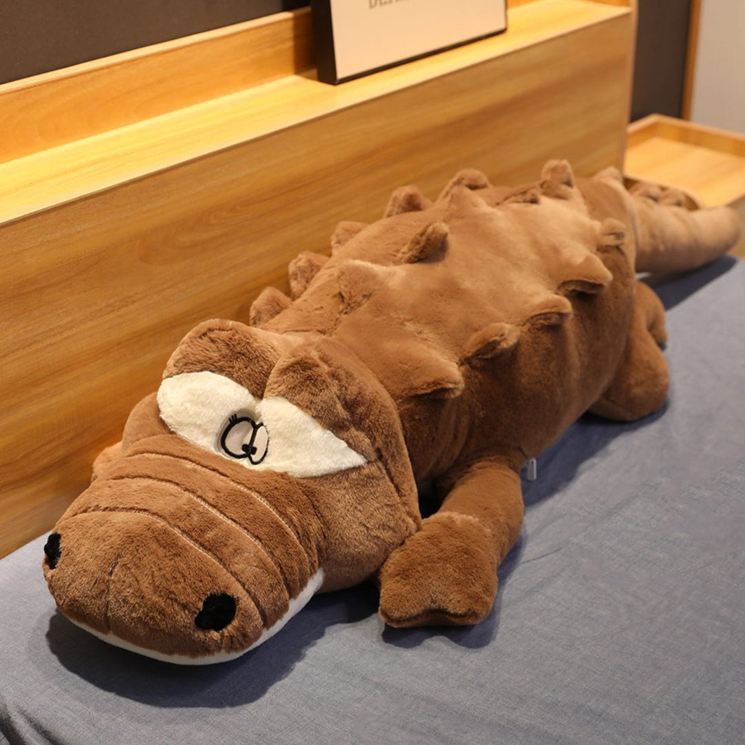 Huggable giant crocodile plush, ideal as a lounge pillow or unique home decor. A soft stuffed animal.