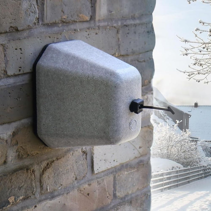 "Gray polystyrene outdoor spigot protector with Velcro strap, providing winter insulation cover for faucets against freeze da