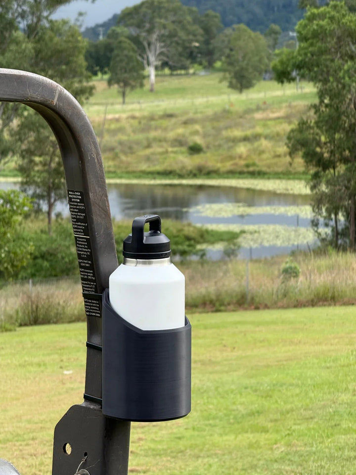 Magnetic tool bottle mount for workshops & garages. Heavy-duty organizer securely holds drinks or sprays.