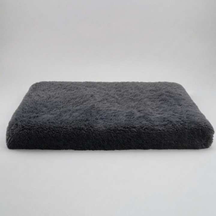 Luxury memory foam dog bed with orthopedic support, providing anti-anxiety calming comfort for pets. Non-slip base.