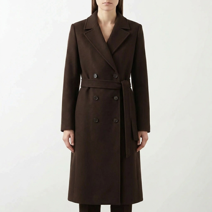 Classic women's tailored long coat, double-breasted with a belt, ideal for elegant fall fashion.