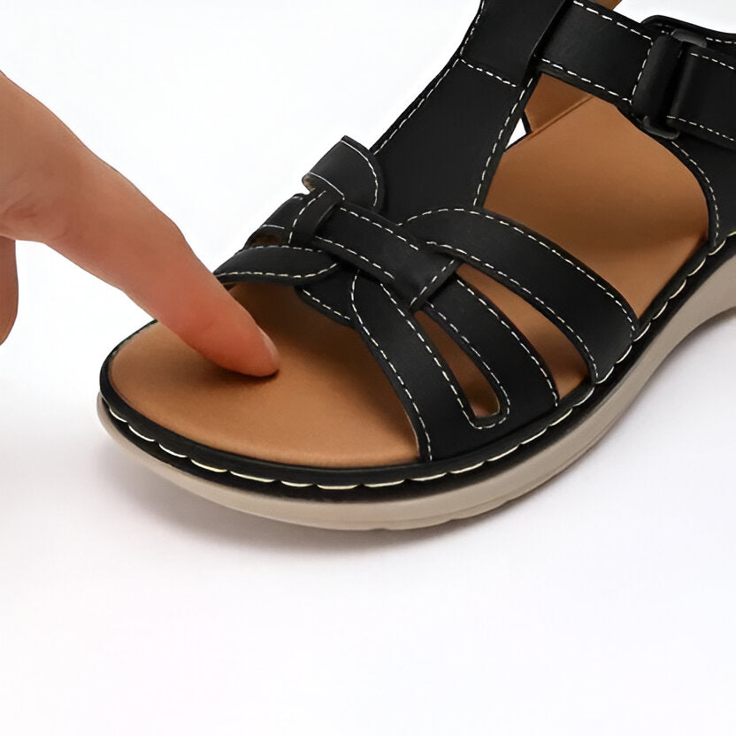 Woman wearing comfortable walking sandals with arch support, enjoying a stroll outdoors.