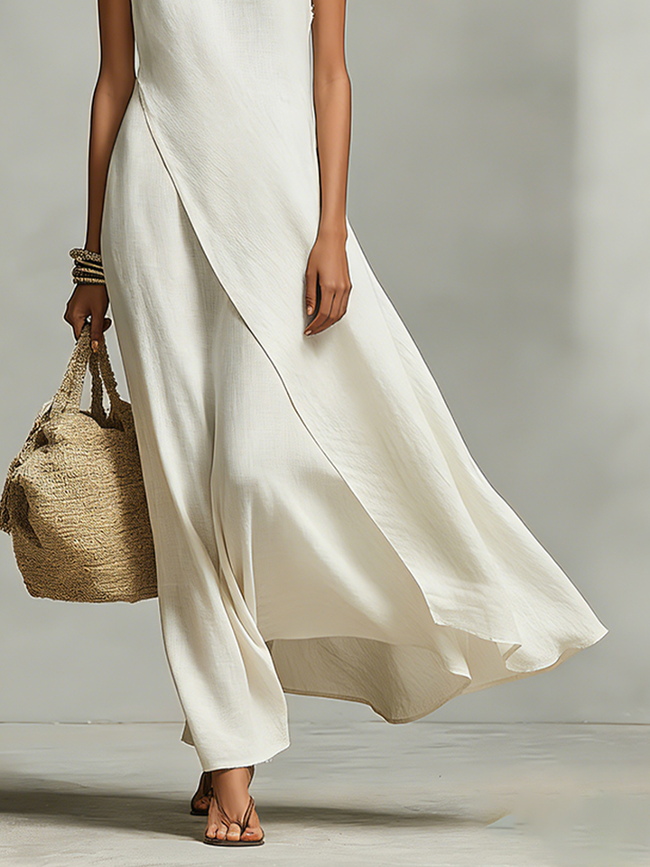 Sleeveless ivory maxi dress for women, with a comfortable flowy fit and stylish asymmetric hem, great for summer.