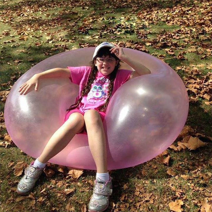 Kids' outdoor fun with a giant tear-resistant inflatable bubble ball, perfect for active summer play.