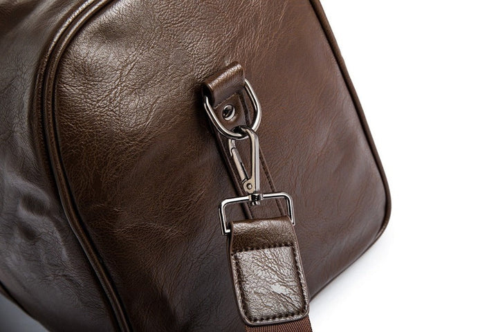Brown faux leather travel duffel bag, lightweight & spacious, perfect unisex carry-on for trips.
