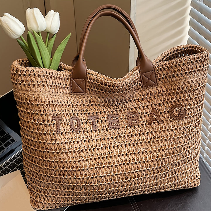 Stylish women's woven shoulder bag featuring durable leather handles & spacious design.