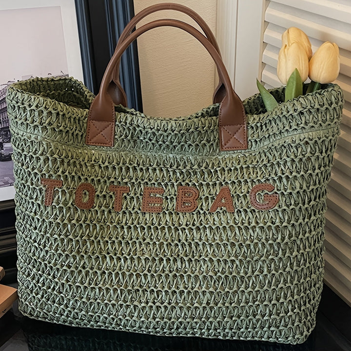 Spacious women's woven handbag with genuine leather handles, a versatile everyday accessory.