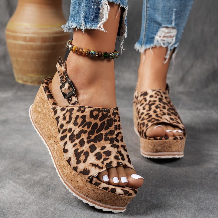 Leopard print platform wedge sandals for women, featuring a comfortable design and buckle strap closure.