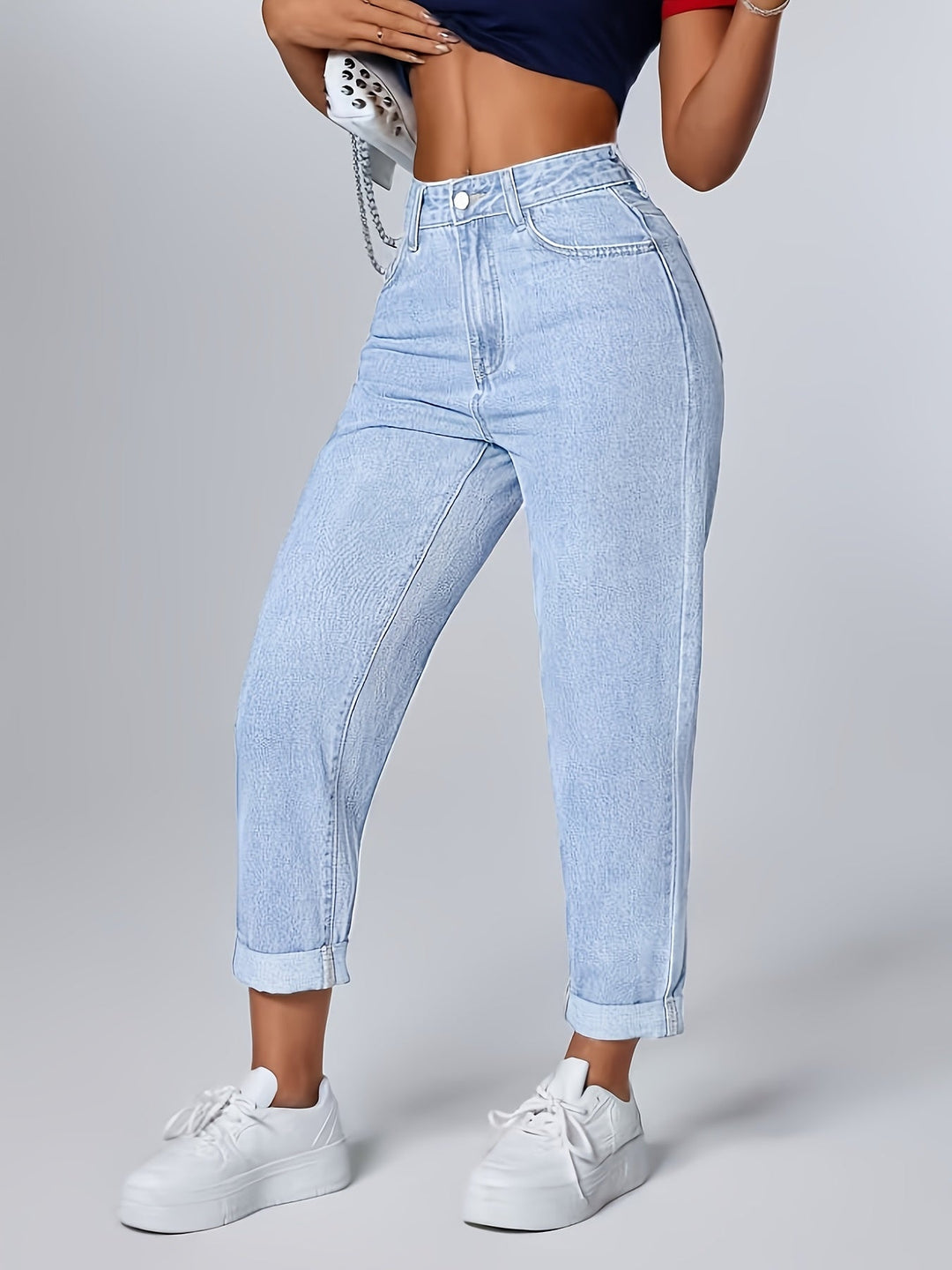 Women's casual light blue denim mom jeans with high waist, relaxed fit, and stylish cuffed hem.