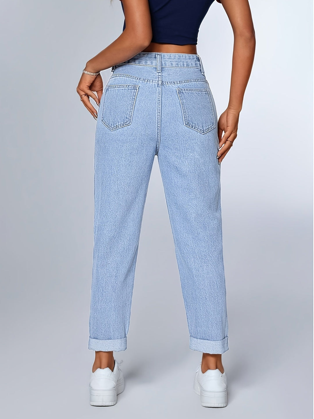 Tapered leg light blue women's mom jeans, high-waist and relaxed fit, with a trendy cuffed hem.