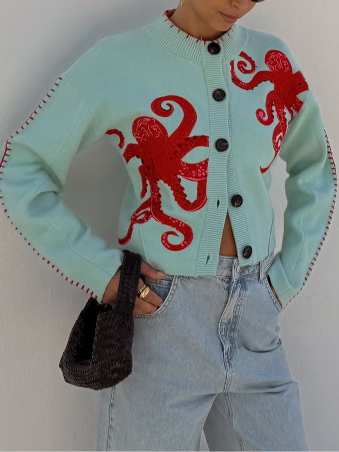 Comfortable women's long-sleeve knit cardigan in light blue. Eye-catching octopus pattern and button front.