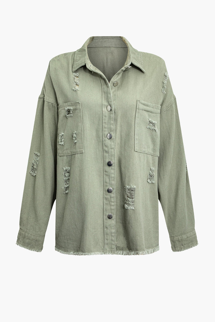 Stylish woman wearing a light green distressed denim jacket, oversized and perfect for casual summer outings.