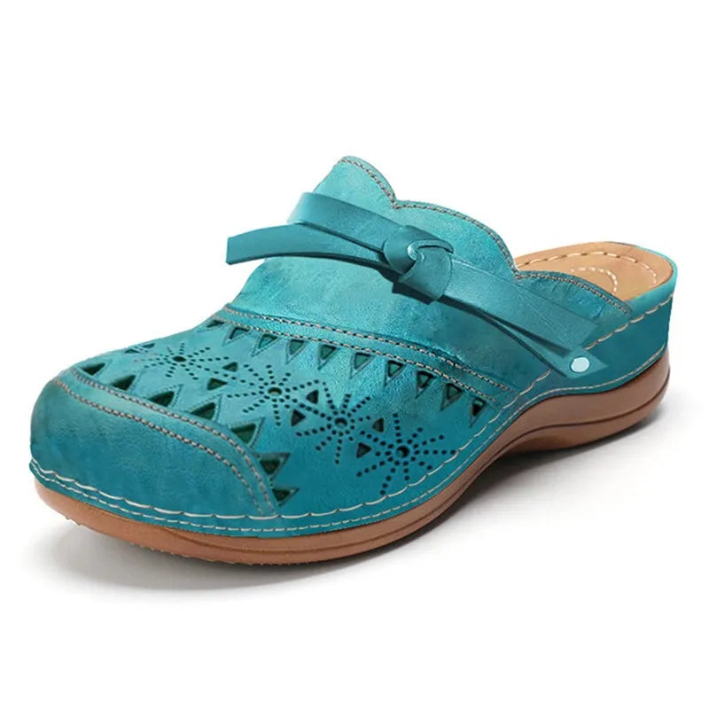 Trendy women's slip-on clogs or sandals. Features a pretty bow accent & modern cutout design.