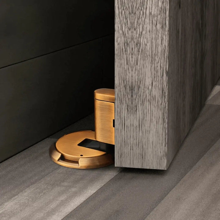 Bronze magnetic door stop. No-drill, self-adhesive design provides wall protection & secure door holding.