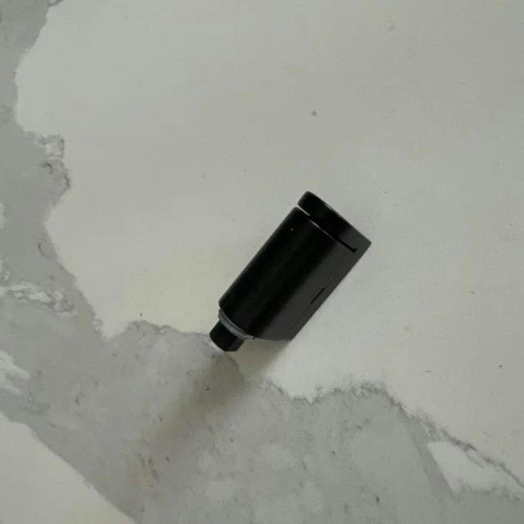 Magnetic door stopper holding a door open. No-drill, self-adhesive bronze door stop for easy use.