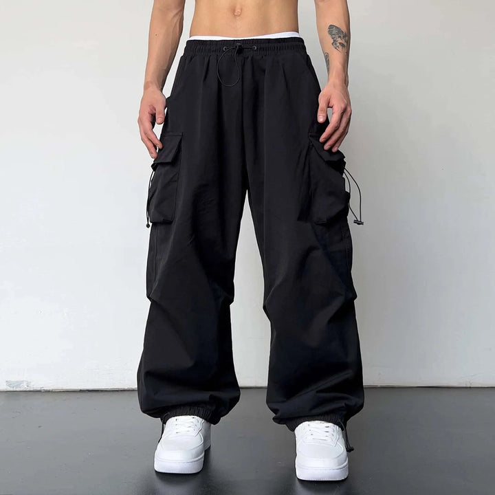 Men's Y2K fashion baggy cargo parachute pants with utility pockets. Comfortable loose fit for casual streetwear.