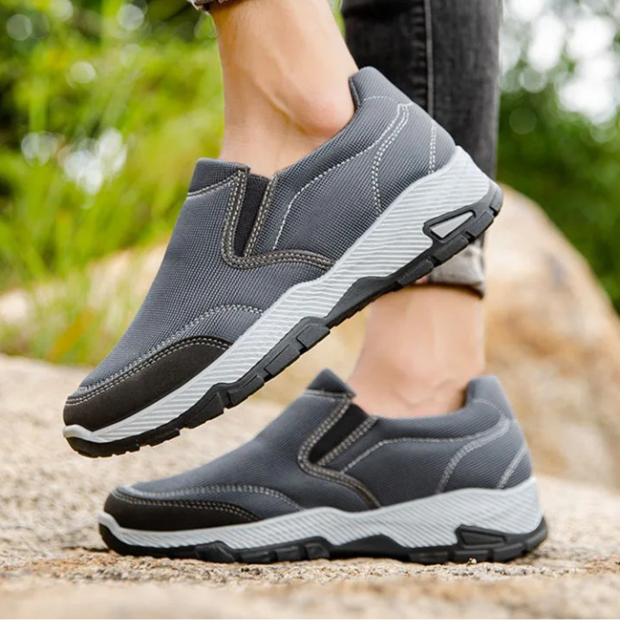 Top view of a single men's gray casual slip-on shoe, highlighting its easy-wear design