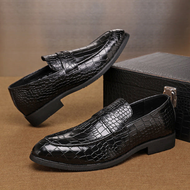 Full shot of men's crocodile embossed leather loafers, a staple in men's style