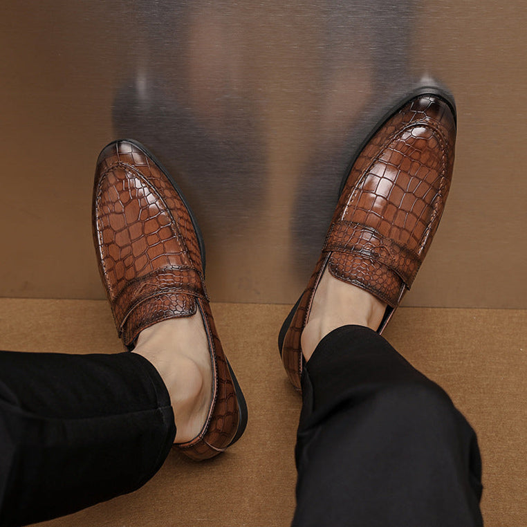Close-up of men's premium brown crocodile embossed leather loafers, formal comfort footwear