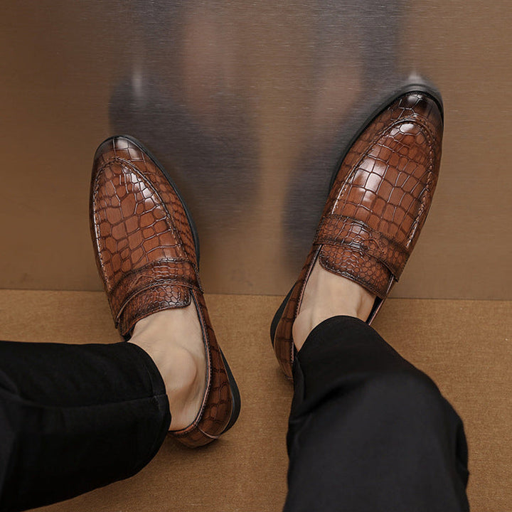 Close-up of men's premium brown crocodile embossed leather loafers, formal comfort footwear