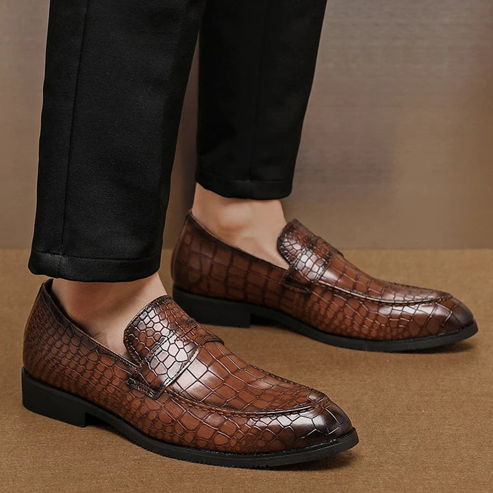 Side view of men's sophisticated crocodile embossed leather loafers, fashionable slip-on shoes