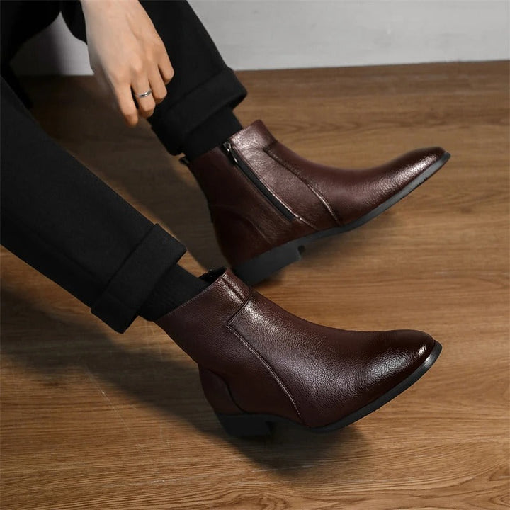 Detailed shot of the side zipper on men's genuine leather ankle boots, highlighting product quality