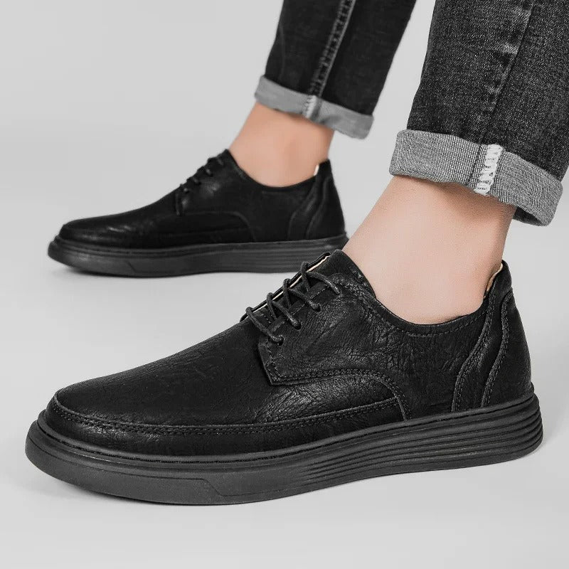 Detail of the sole on a men's leather dress sneaker, emphasizing shock absorption and durability.