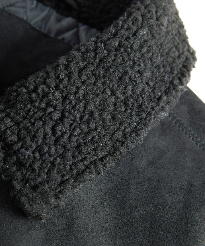 Front view of a men's insulated quilted bomber jacket with a prominent sherpa collar, great outerwear.