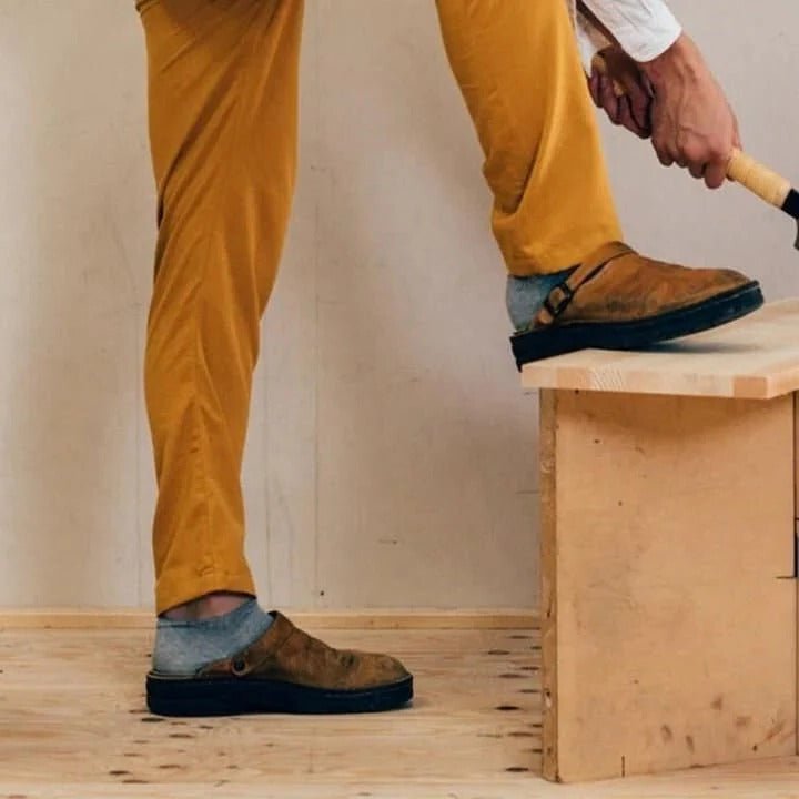 Versatile men's slip-on mules with a secure heel strap, providing easy comfort for indoor and outdoor activities.