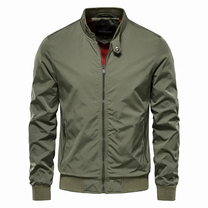 Close-up of a men's gray streetwear zip jacket, showing textured fabric and zipper detail. Urban outerwear.