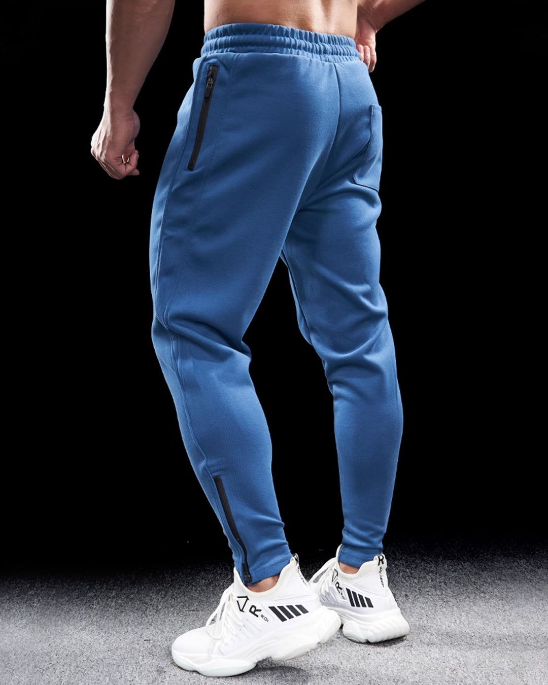 Athletic men's cotton blend joggers, tapered fit, visible zippered hems, perfect for casual wear or sports.