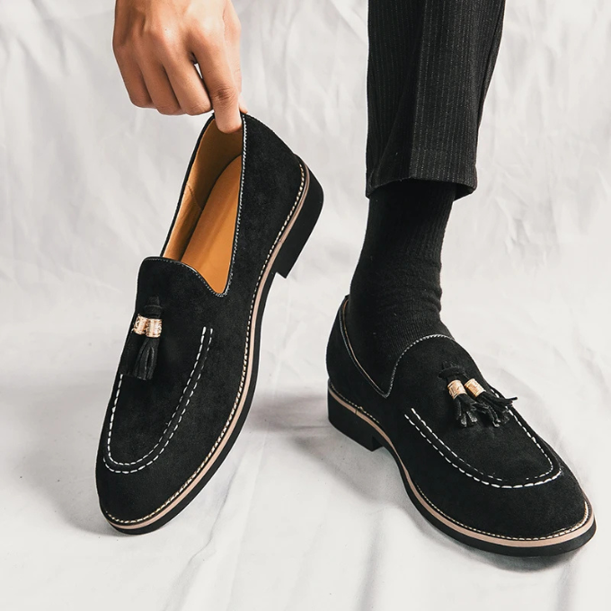 Footwear image showcasing men's velvet tassel loafers from a top-down view