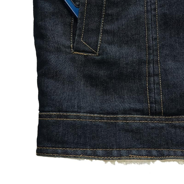 Detailed shot of the fleece lining inside a men's blue denim jacket
