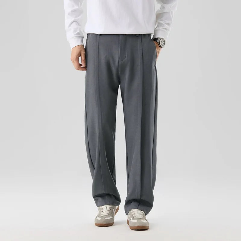 Black Brunello men's drape trousers. Versatile pleated pants for sophisticated formal or casual looks.