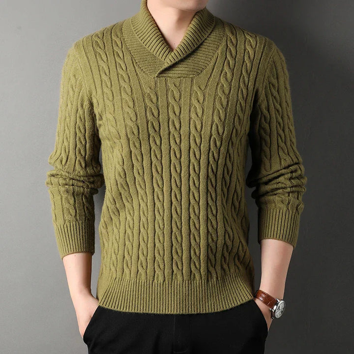 Close-up of a men's long sleeve cable knit pullover sweater, showing the detailed knit pattern and cashmere blend.