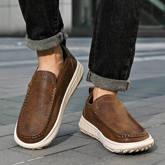 Close-up of the texture of a men's brown leather slip-on loafer, durable and fashionable.