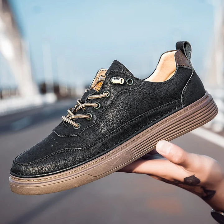 Back view of men's beige leather sneakers, highlighting the sole and heel