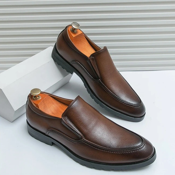 Side view of a comfortable men's slip-on loafer, showcasing its durable sole and easy-wear design.