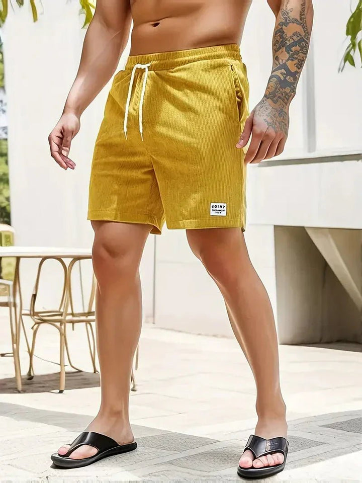 Fashionable men's drawstring corduroy shorts, versatile for casual and beach wear.
