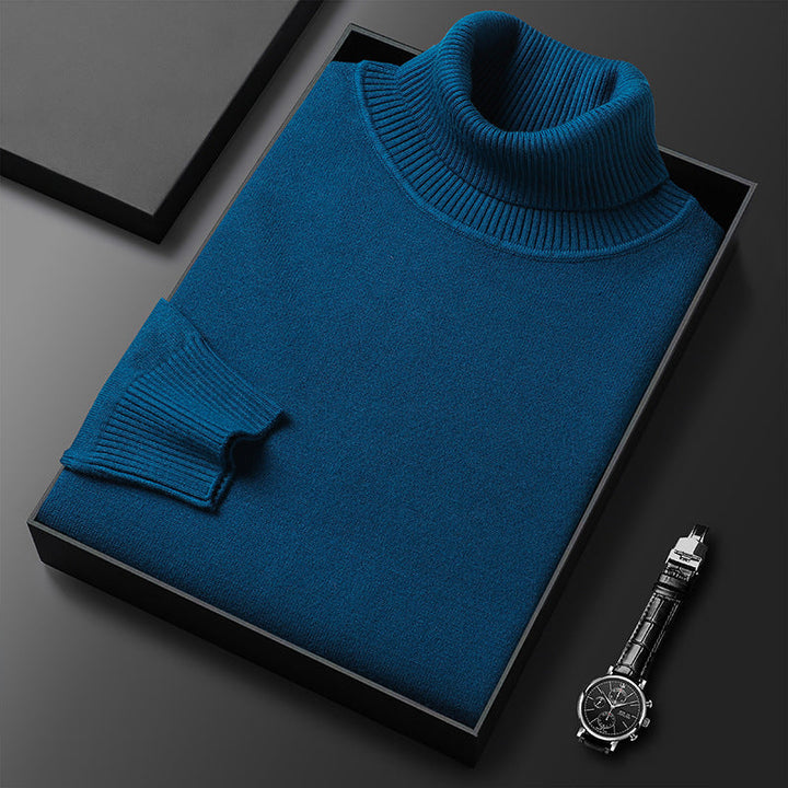 Men's turtleneck sweater paired with dark pants, a classic smart casual spring outfit.