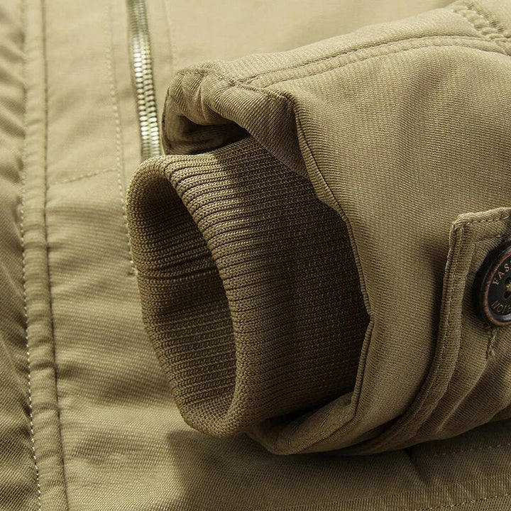 Close-up of the sturdy zipper and snap button closure on the men's corduroy winter jacket